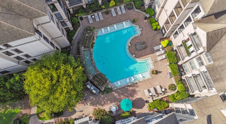 Aerial view of a pool area surrounded by greenery