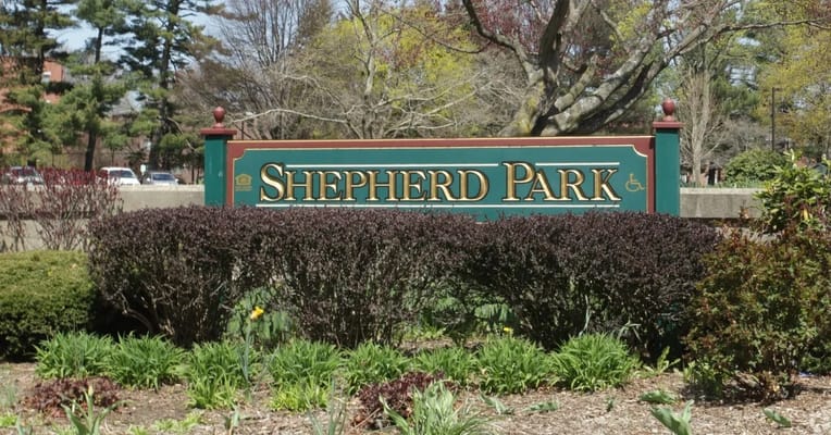 Sign for Shepherd Park Elderly Housing surrounded by greenery