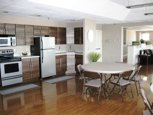 Bright communal kitchen area with dining table