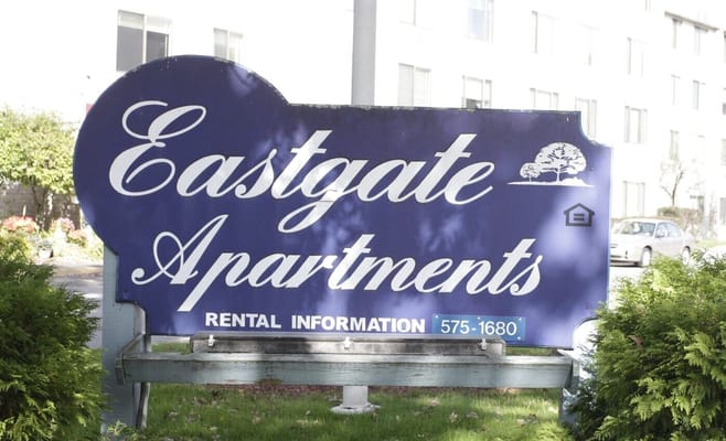 Sign for East Gate Apartments with rental information