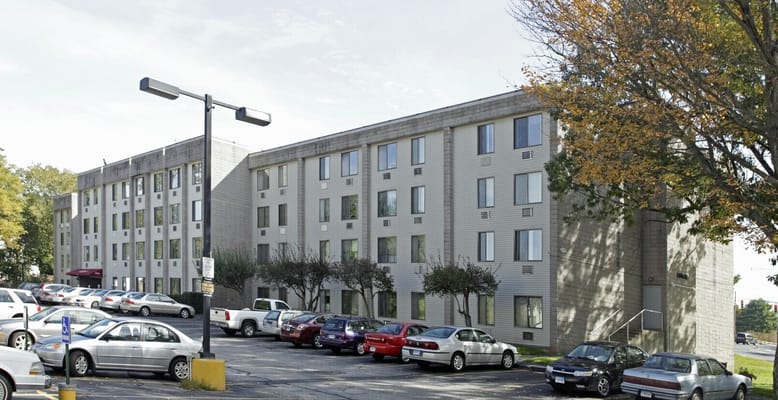 View of East Gate Apartments building with parking lot