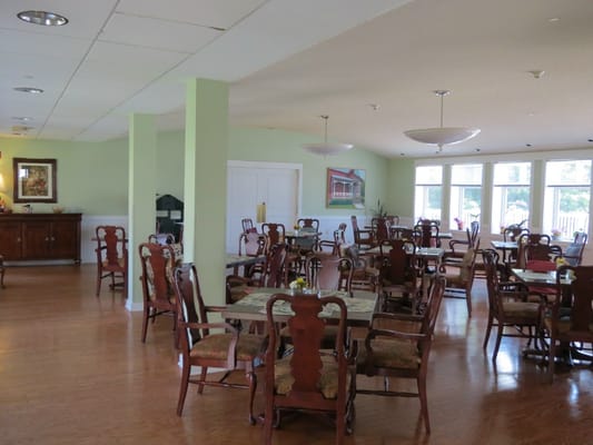 Spacious dining room with wooden tables and chairs