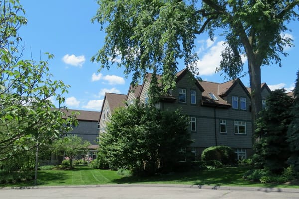 A view of the Hill House senior living facility surrounded by greenery.
