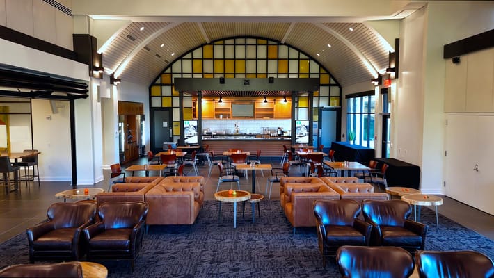 Interior view of a common area with seating and kitchenette