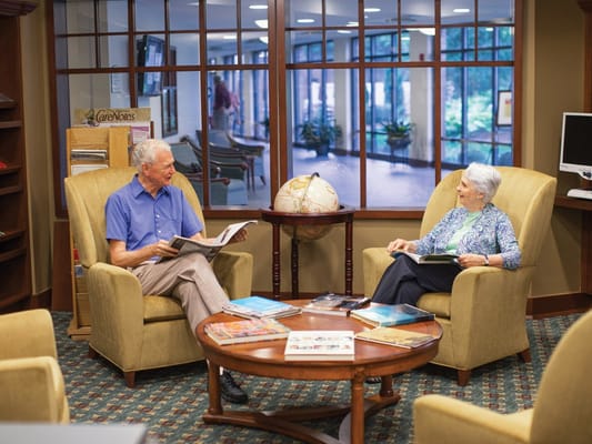 Residents enjoying conversation in a cozy lounge area