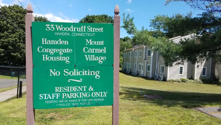 Sign for Mount Carmel Village and parking rules