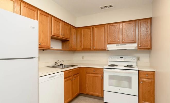 Bright kitchen with wooden cabinets and appliances