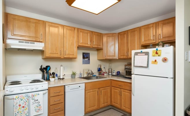 A well-lit kitchen with wooden cabinets and modern appliances.