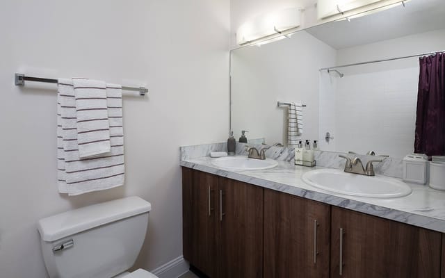 Well-equipped bathroom with double sinks and modern fixtures.