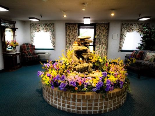 Decorative fountain surrounded by flowers in the lobby