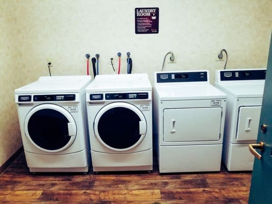 Laundry machines in the laundry room of Willow Arms Apartments.
