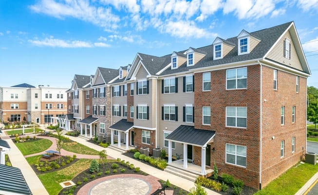Exterior of Linden Hill Station Apartments showcasing the brick and siding architecture.