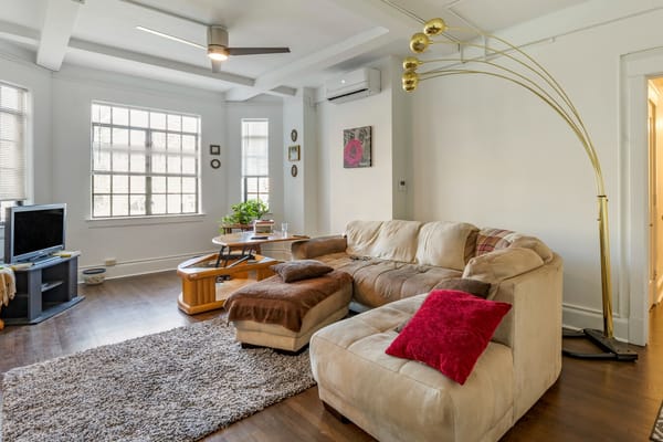 Bright interior of a cozy sitting area with a couch and TV