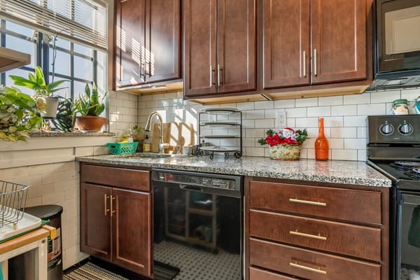 Well-lit kitchen area with dark wood cabinets