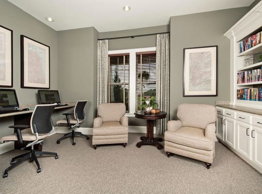 Cozy computer area with two chairs and a table