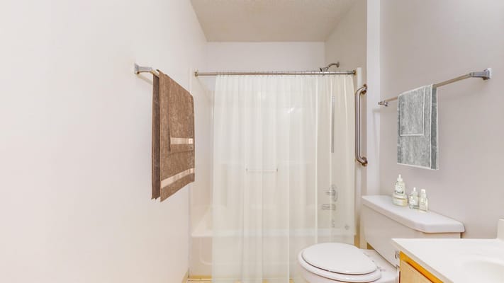 Bright and spacious bathroom with a shower and modern amenities