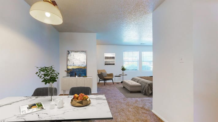 A bright and inviting living area with a dining table and armchair.