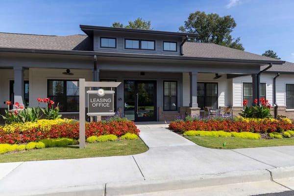 Exterior view of the leasing office with flower beds
