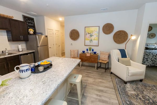 Well-furnished apartment interior with kitchenette and living area