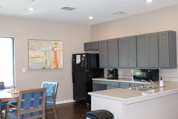 Modern kitchen with grey cabinets and a dining area
