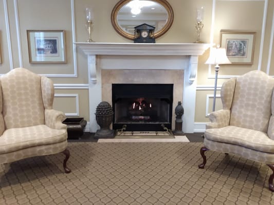 Cozy common area with armchairs and fireplace