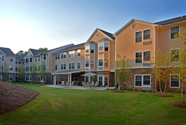 Exterior view of a senior living facility with landscaped grounds
