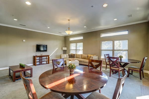 Bright common area with seating and dining tables