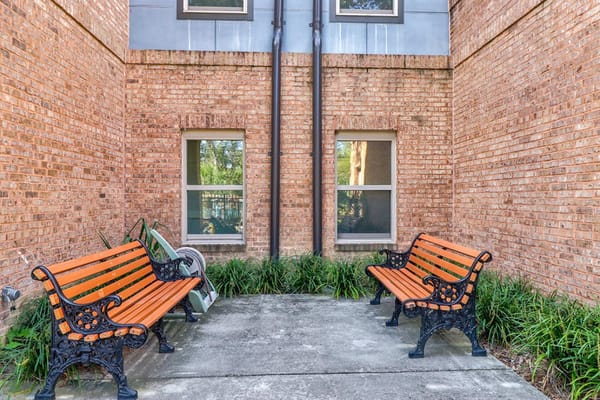 Outdoor seating area with benches and plants