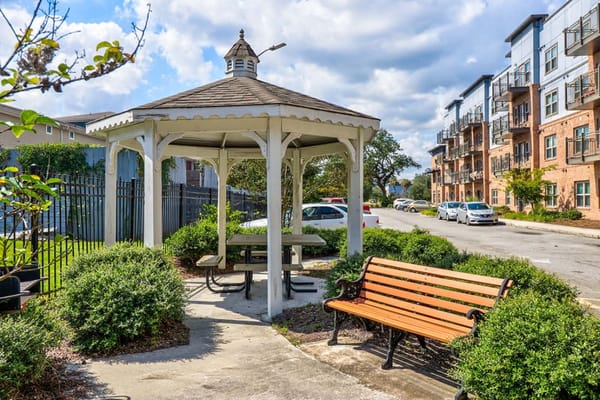 Outdoor gazebo with picnic tables and benches