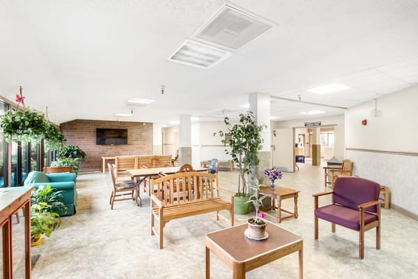Bright and spacious common area with seating and plants.