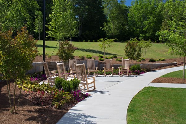 Outdoor seating area with rocking chairs and garden