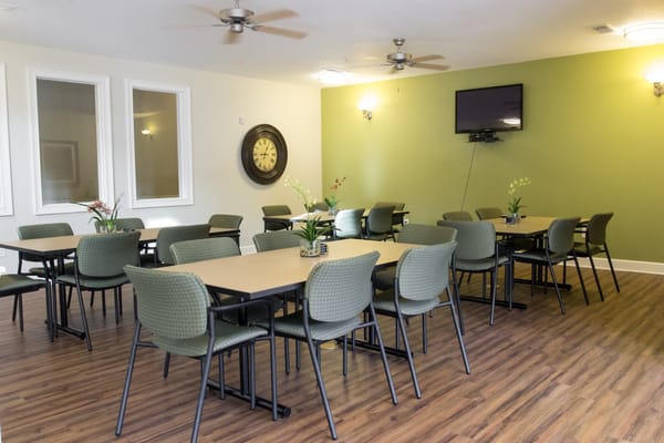 Dining area with tables and chairs in a well-lit room