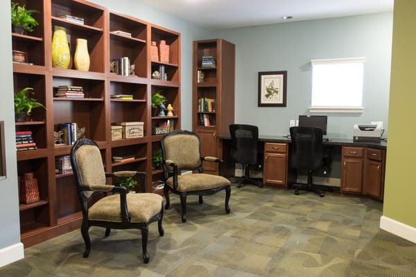 A cozy reading area with bookshelves and chairs