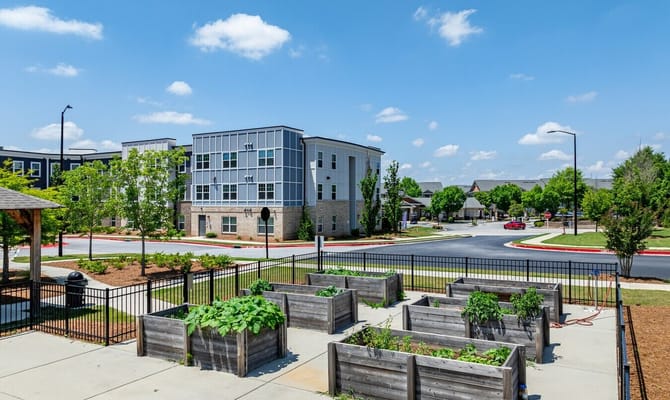 Exterior view of assisted living facility with gardens
