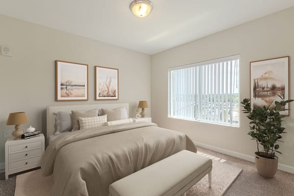 Stylish bedroom with beige bedding and decorative artwork