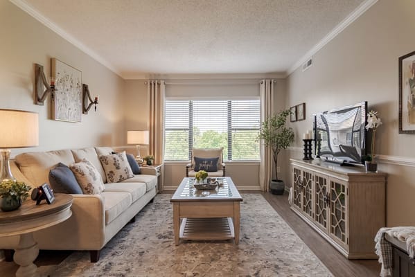 Inviting living room with a sofa, coffee table, and window view.