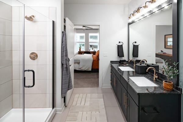 Modern bathroom with dual sinks and shower
