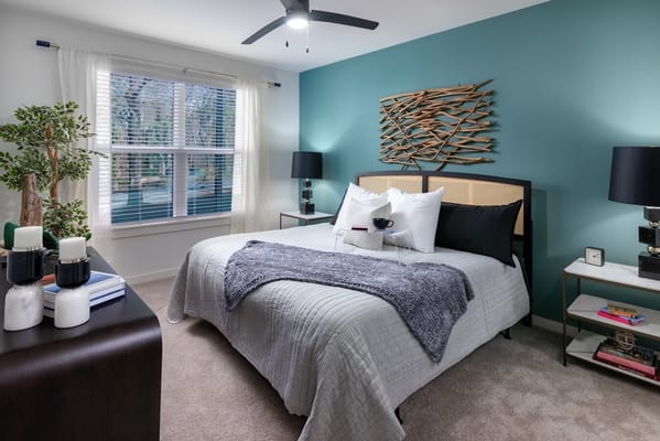 A neatly arranged bedroom with modern decor and natural light
