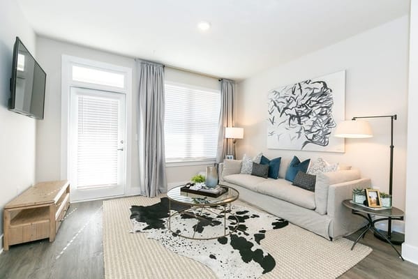 Light-filled living room with a sofa and decorative pillows