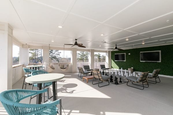 A cozy outdoor lounge area with chess pieces and seating