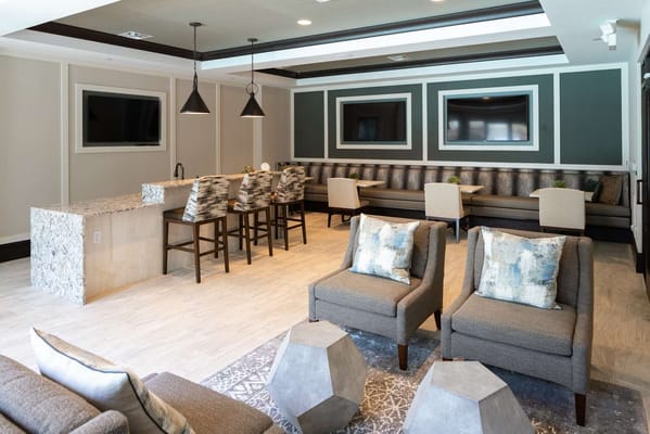 Modern lounge area with seating and bar space