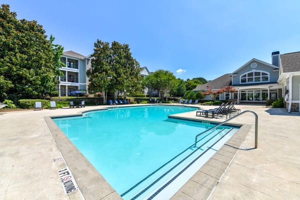 Swimming pool area with seating and landscaping