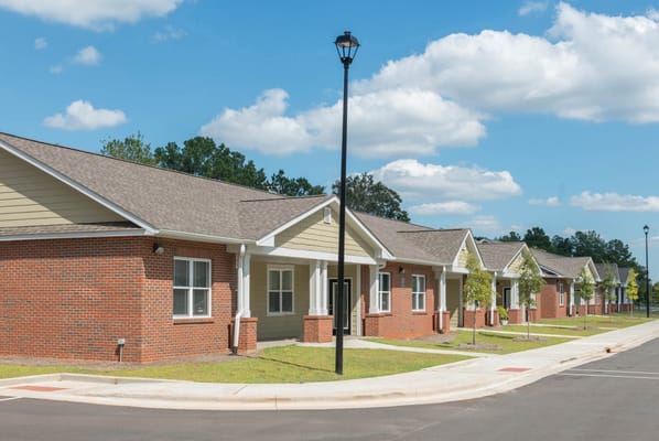 Exterior view of a senior living facility with landscaped grounds