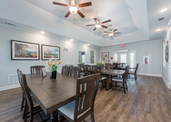 Bright common area with tables and artwork