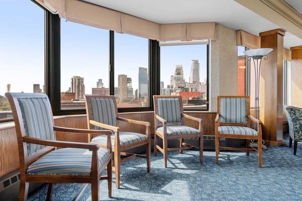 Bright common area with chairs and city view
