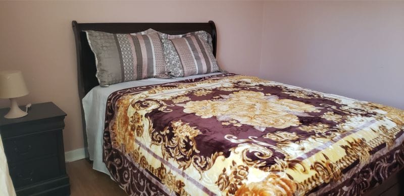Cozy bedroom with a decorative blanket and pillows