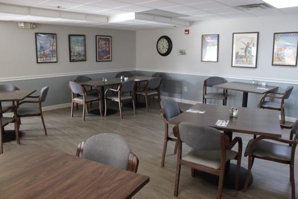 Dining room with wooden tables and framed art