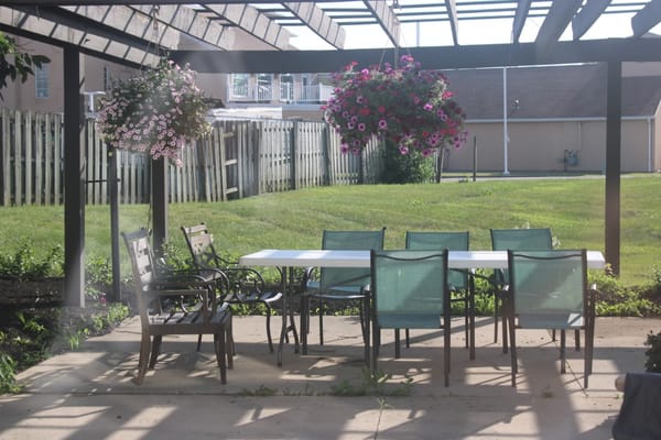 Outdoor patio with seating and hanging flowers