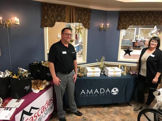 Staff members at an event showcasing treats and decorations