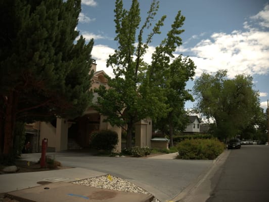 Exterior view of the facility with trees and gardens